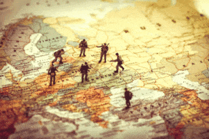 Figures of soldiers standing on a map of Eastern Europe, encircling Ukraine