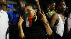 The woman above has written “Just Fall“ on her arm, reflecting the demonstrators' calls for President Omer Al Bashir and his government to resign. Image was taken in Khartoum Sudan during Sudan sit-in.