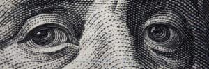 Close-up of Benjamin Franklin's face on hundred banknote.