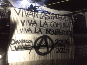 A barricade in Oaxaca with revolutionary slogans.