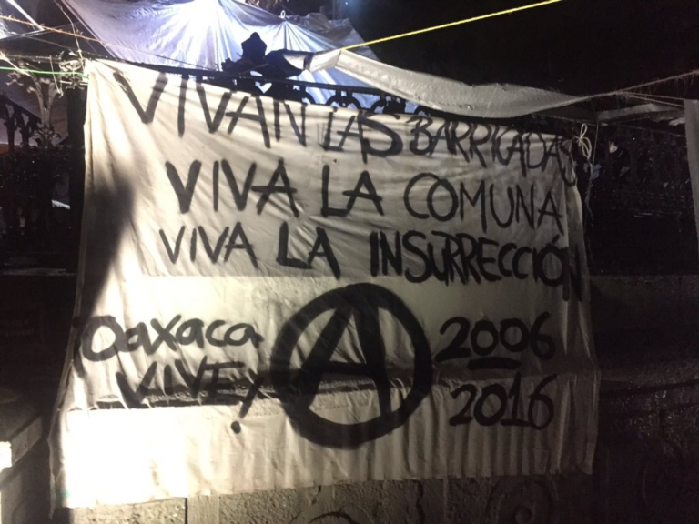 A barricade in Oaxaca with revolutionary slogans.