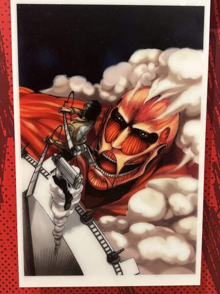 A wall panel at the Attack on Titan installation at Kodansha House in New York City, October 2025. The image, depicting main character Eren Yeager fighting the Colossal Titan, appears on the cover of the first volume of the Attack on Titan manga series, created by Hajime Isayama and published in 2012 by Kodansha.