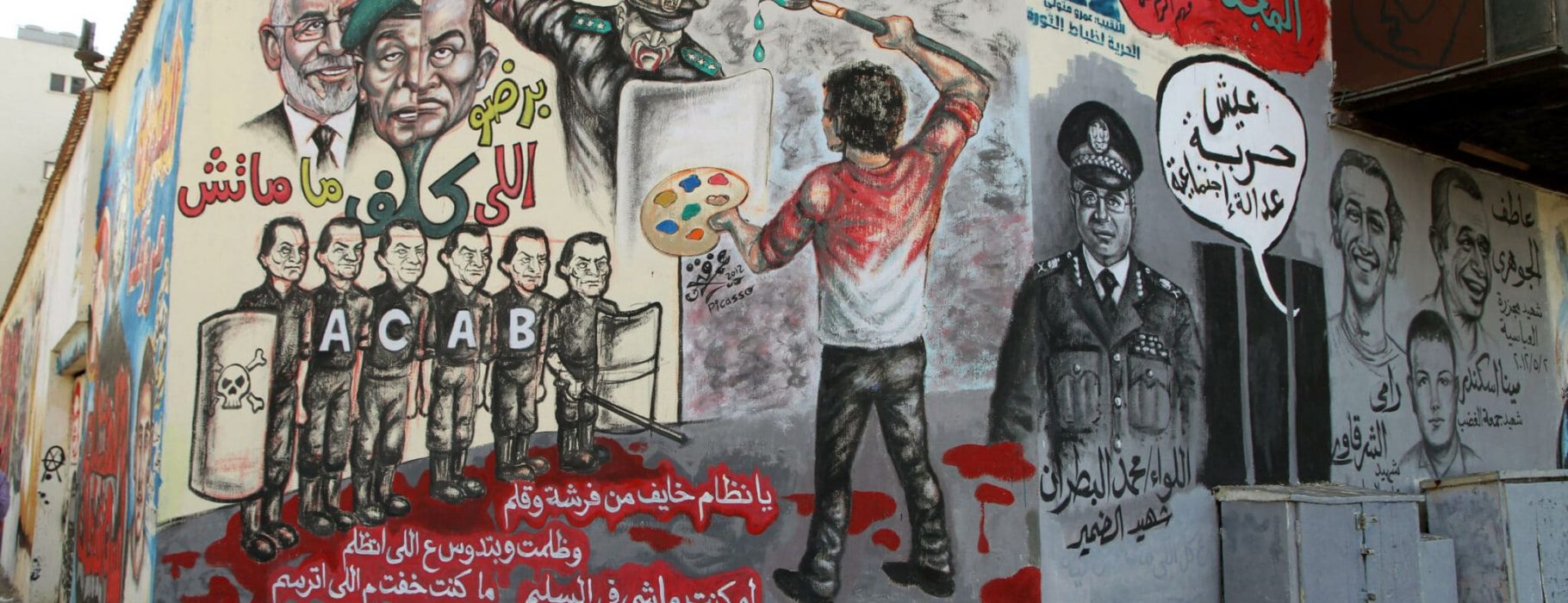 A painter uses his brush against a policeman armed with a mace. This mural is at the intersection of Muhammad Mahmud Street and Tahrir Square, Cairo, Egypt.