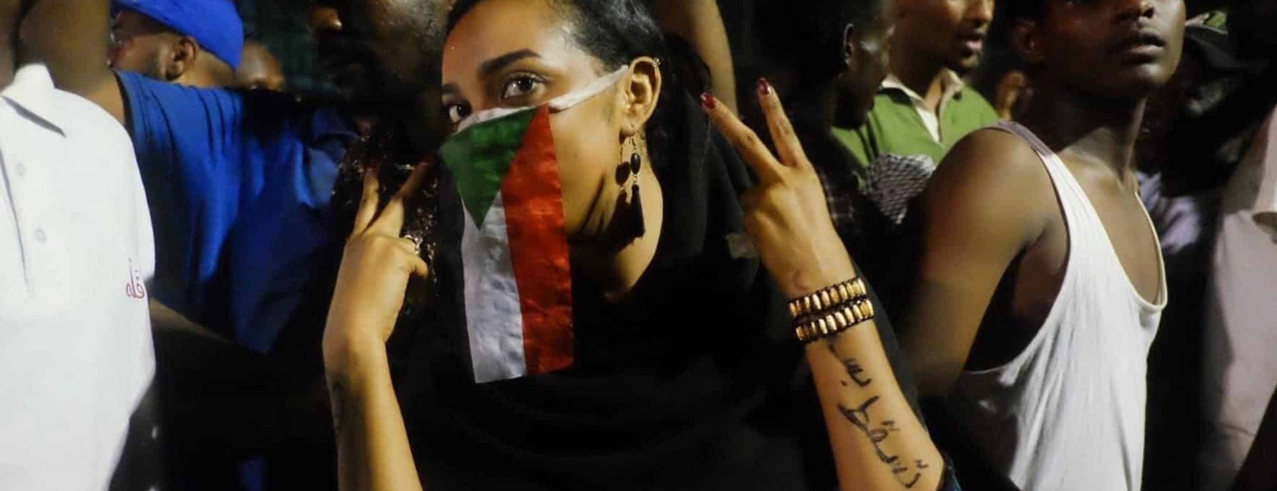 The woman above has written “Just Fall“ on her arm, reflecting the demonstrators' calls for President Omer Al Bashir and his government to resign. Image was taken in Khartoum Sudan during Sudan sit-in.