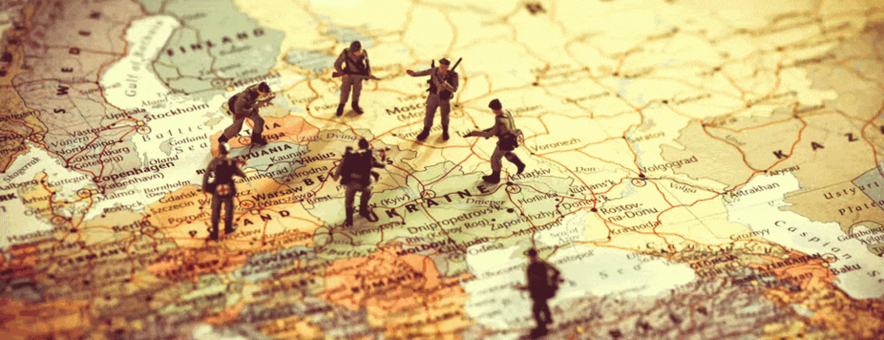 Figures of soldiers standing on a map of Eastern Europe, encircling Ukraine